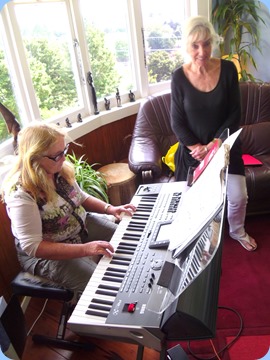 Desiree Barrows playing the Korg Pa3X like a seasoned pro whilst Delyse is watching on absorbed
