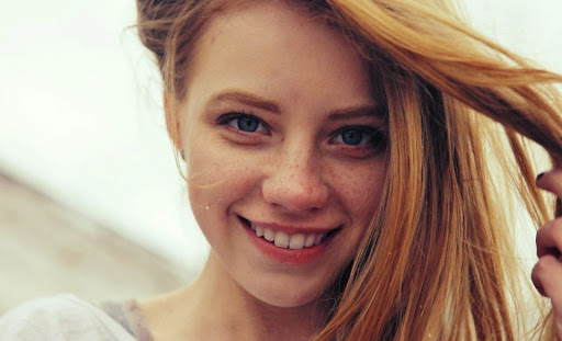 Blue Eyed Girl with Freckles Smiling