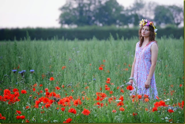 girl standing in wild flowers