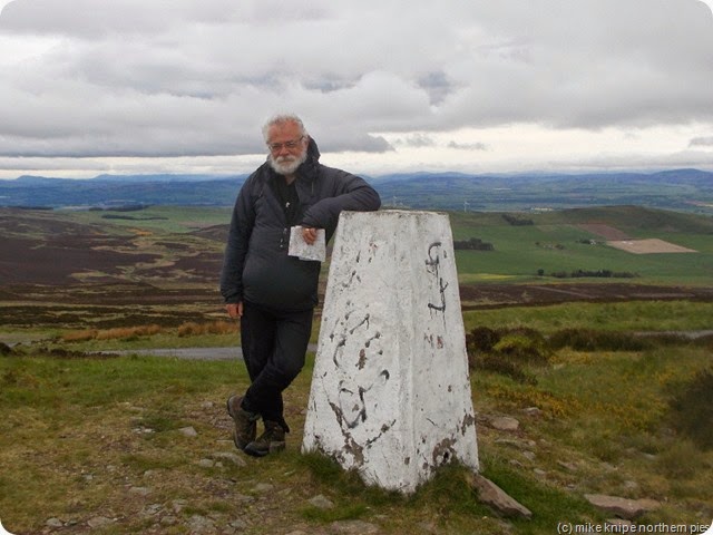 me dogless with lowering dark clouds on craigowl hill