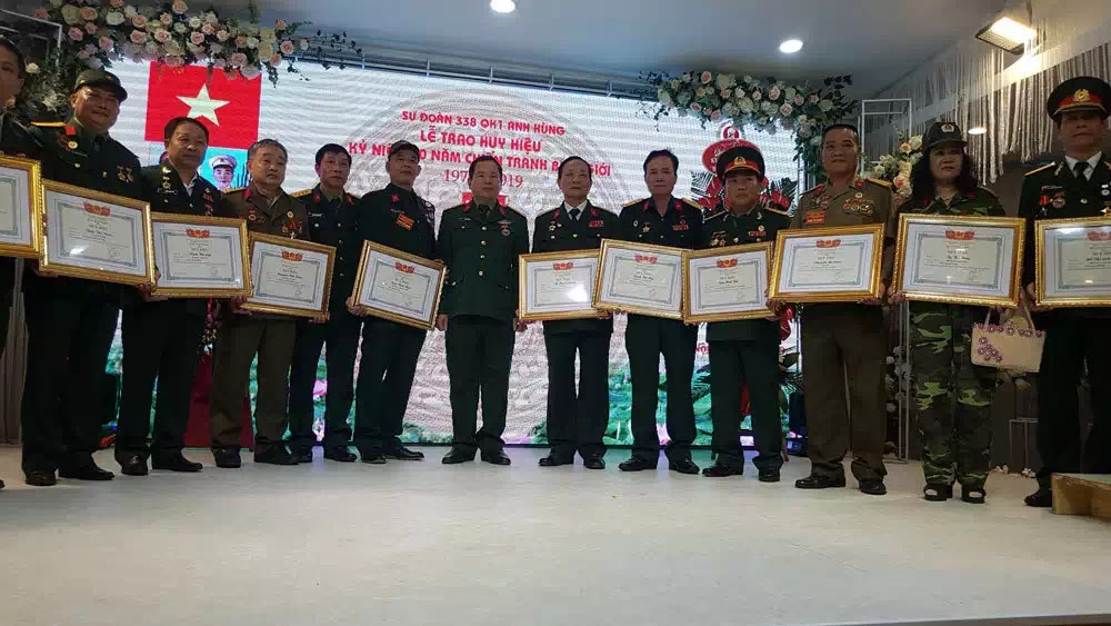 Đại tá Tạ Đức Thanh (Đoàn trưởng Đoàn 338, đứng giữa) trao huy hiệu cho các cán bộ, chiến sỹ