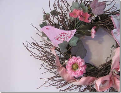 Twig wreath with pink bird.