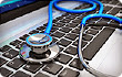 stethoscope on laptop keyboard