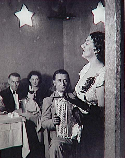 Brassaï ~ Kiki singing in Cabaret des Fleurs, c.1932.jpg