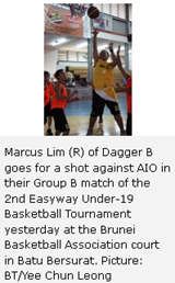 Marcus Lim (R) of Dagger B goes for a shot against AIO in their Group B match of the 2nd Easyway Under-19 Basketball Tournament yesterday at the Brunei Basketball Association court in Batu Bersurat. Picture: BT/Yee Chun Leong 