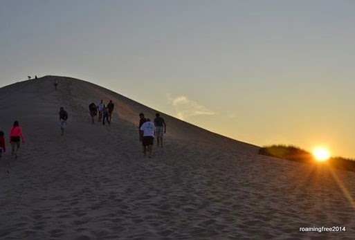 Climbing the dune on the sunset tour