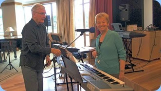 Gordon Sutherland helping to set-up the microphone stand for Diane Lyons who played her lovely Korg Pa900 and with vocals. Photo courtesy of Dennis Lyons