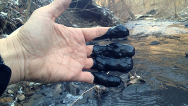 Coal slurry coats the hand of Director of Programs Dr. Matt Wasson following a slurry spill into Fields Creek in Kanawha County, West Virginia, on Tuesday, 11 February 2014. Photo: Matt Wasson / Appalachian Voices