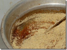 Adding ground green gram mixture to the jaggery syrup