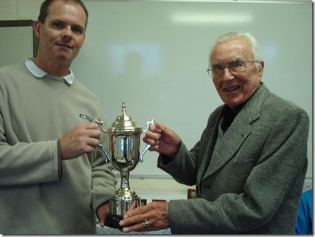 Men’s Singles Final - Geoff Armitage presents the trophy to Jonathan Braithwaite