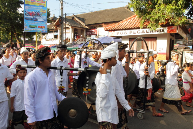 Balinese men play music during a procession at Ubud, Indonesia