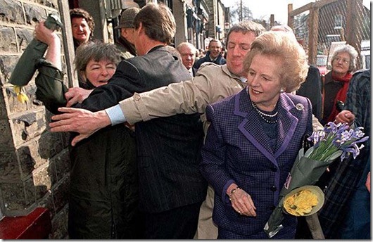 Low carbon economy summit...File photo dated 23/3/1992 of former Conservative Prime Minister Margaret Thatcher is attacked by a woman wielding a bunch of flowers,  during a walkabout in Marple Bridge in Stockport. Lord Mandelson is the latest Government minister to be the target of a colourful stunt by protesters. PRESS ASSOCIATION Photo. Issue date: Friday March 6 2009. A climate change activist threw a cup of green "slime" over Business Secretary Lord Mandelson today as he arrived at the launch of the Government's low carbon economy summit. See PA story POLITIOCS Carbon Protests. Photo credit should read: Malcolm Croft/PA Wire