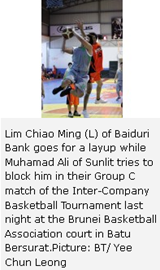 Lim Chiao Ming (L) of Baiduri Bank goes for a layup while Muhamad Ali of Sunlit tries to block him in their Group C match of the Inter-Company Basketball Tournament last night at the Brunei Basketball Association court in Batu Bersurat.Picture: BT/ Yee Chun Leong 