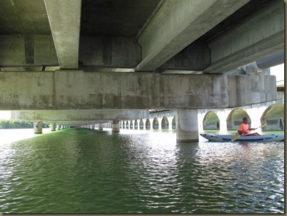 al kayaking under bridge