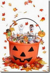 10762286-halloween-pumpkin-bucket-with-candy-and-falling-leaves