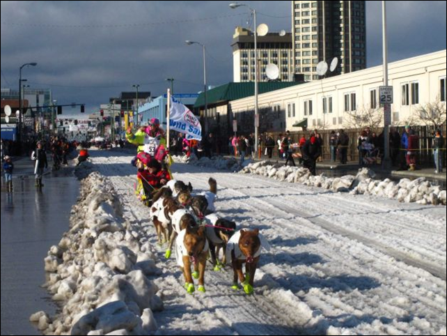 Musher Monica Zappa of Kasilof, Alaska, leads her team past spectators Saturday, 7 March 2015, during the ceremonial start of the Iditarod Trail Sled Dog Race in Anchorage, Alaska. The official start is Monday in Fairbanks, where the race was moved because of a lack of snow to the south. Photo: Rachel D'Oro / AP