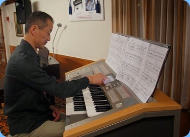 Taka using the touch screen to set-up his next piece. Photo courtesy of Dennis Lyons.