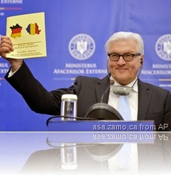 German Foreign Affairs Minister Steinmeier holds brochure with German flag superimposed on French border