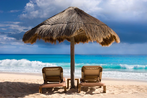 Get recharged by relaxing along a gorgeous beach in Cancun, Mexico.