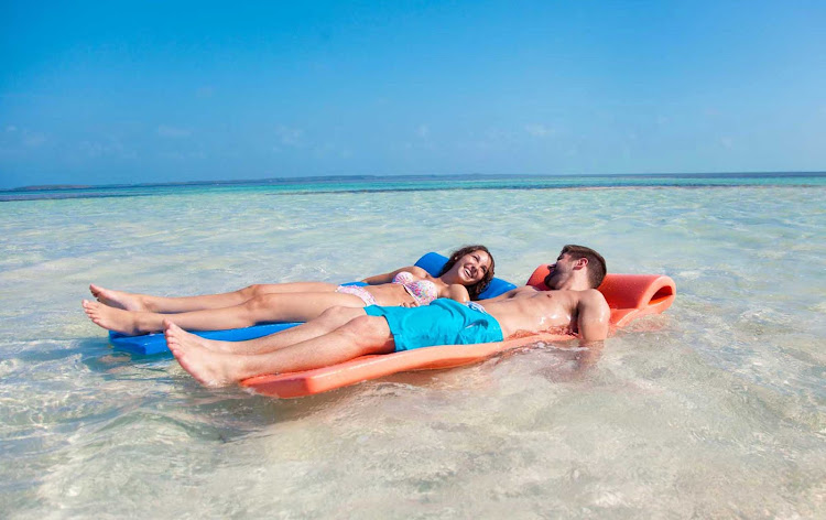 Relax on a floating mat with your sweetie during a day trip to CocoCay in the Bahamas. 