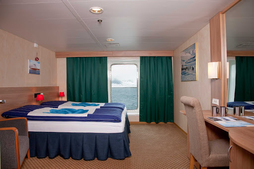 Arctic-Expedition-Category-4-Cabin-Stateroom - The Cabin 4 Stateroom aboard Expedition from G Adventures has two twin beds that convert to a king-size bed and a large window for watching the passing landscapes.