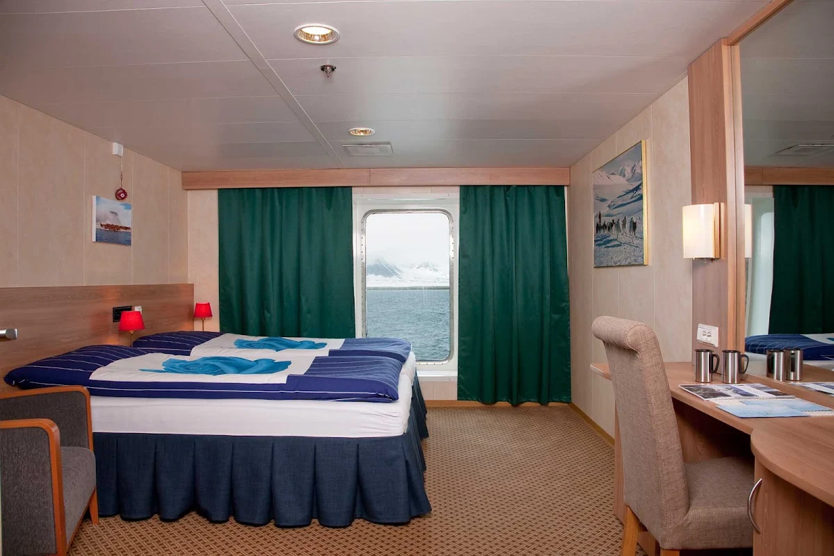 Arctic-Expedition-Category-4-Cabin-Stateroom - The Cabin 4 Stateroom aboard Expedition from G Adventures has two twin beds that convert to a king-size bed and a large window for watching the passing landscapes.