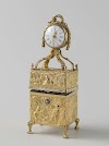 Nécessaire van goud met op het deksel een staand horloge