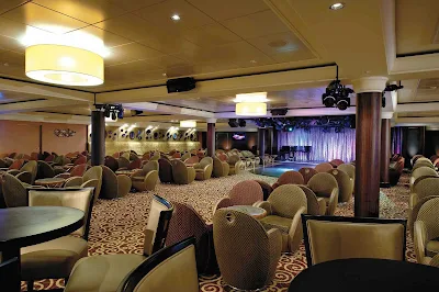 Dance the night away at the Spinnaker Lounge, one of the cozy yet festive spots aboard  Norwegian Dawn.