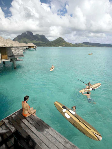 Recreation options include stand-up paddle boarding at the Four Seasons Resort Bora Bora.