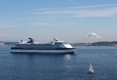 Celebrity Infinity sails out of Seattle Harbor with Mt. Rainier in the background.