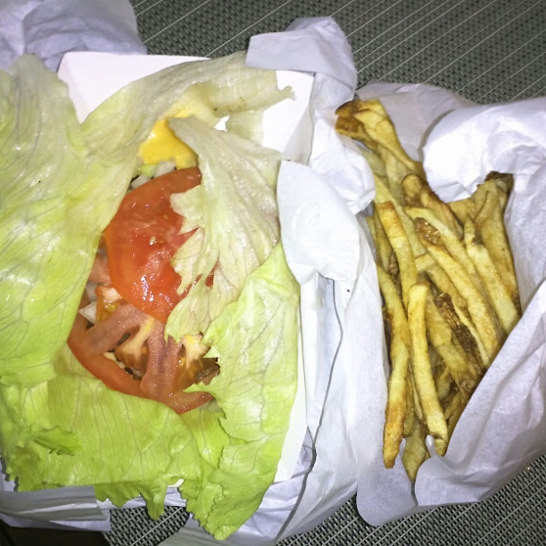 Burger wrapped in lettuce and fries