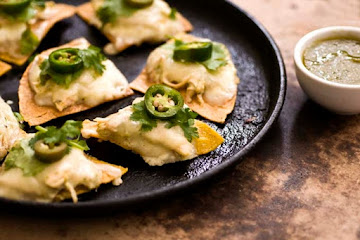 Sour cream chicken nachos with poblano salsa verde