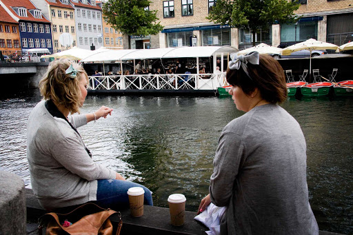 Copenhagen-canal-locals - Two local women take a break at a canal in Copenhagen. 