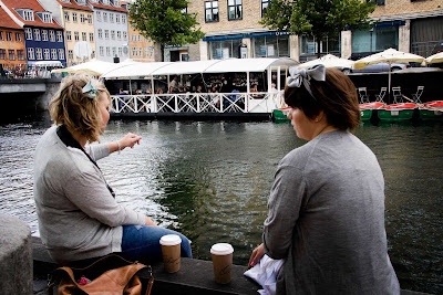 Two local women take a break at a canal in Copenhagen. 
