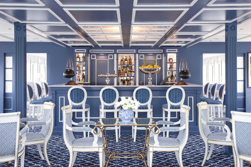Enjoy a glass of fine wine in Uniworld's River Queen's classy bar and lounge while making your European river cruise.