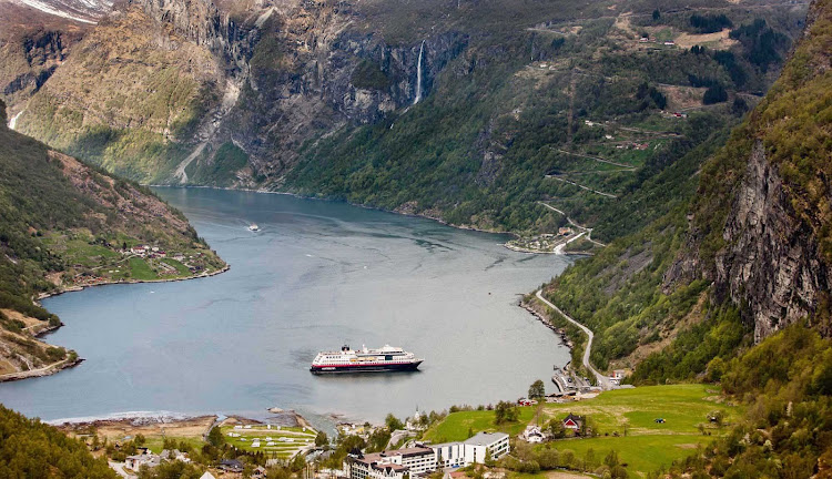 Travel to the UNESCO-protected fjord Geirangerfjord in Norway on board Hurtigruten's ms Midnatsol and experience spectacular views of snow-covered mountain ranges, waterfalls and abandoned farms.