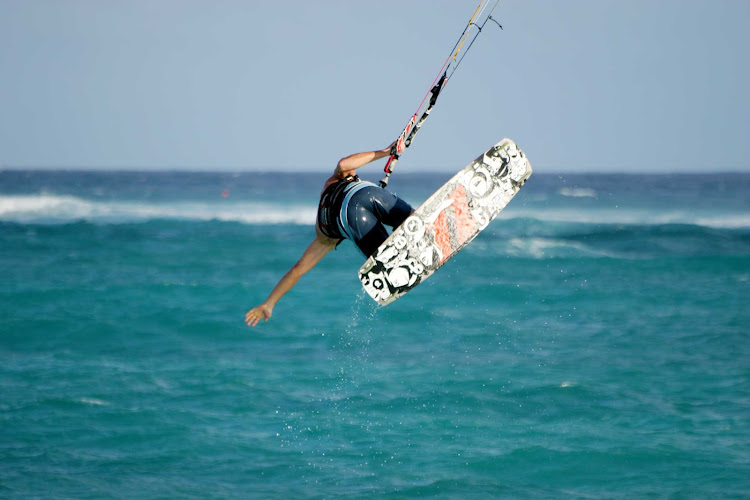 Kitesurfing — sometimes called kiteboarding or sailboarding — on Barbados.