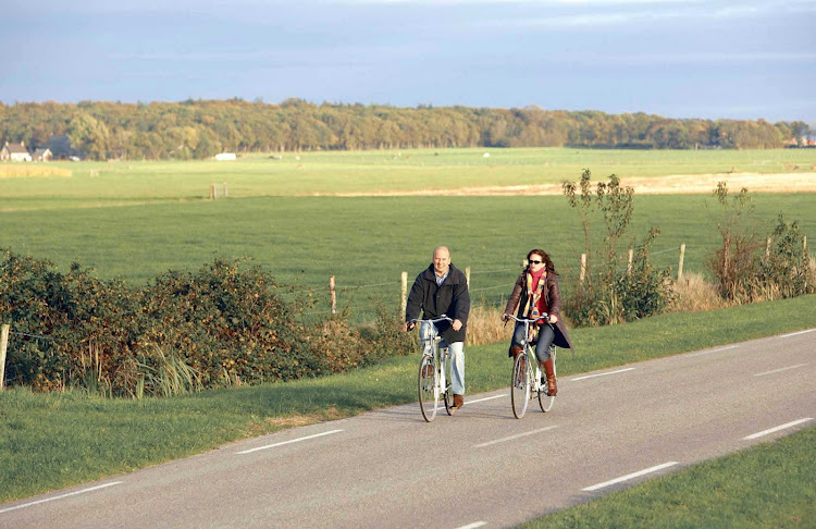 Bicycling through fields in the Netherlands.