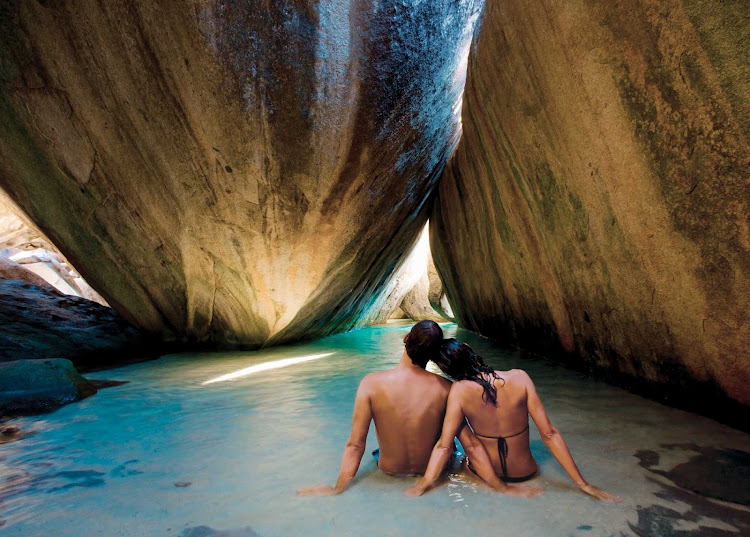 Share a romantic moment in a secluded lagoon during a shore excursion to Virgin Gorda in the British Virgin Islands.