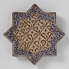 Star-shaped tile with stylized plants and pseudo-inscription