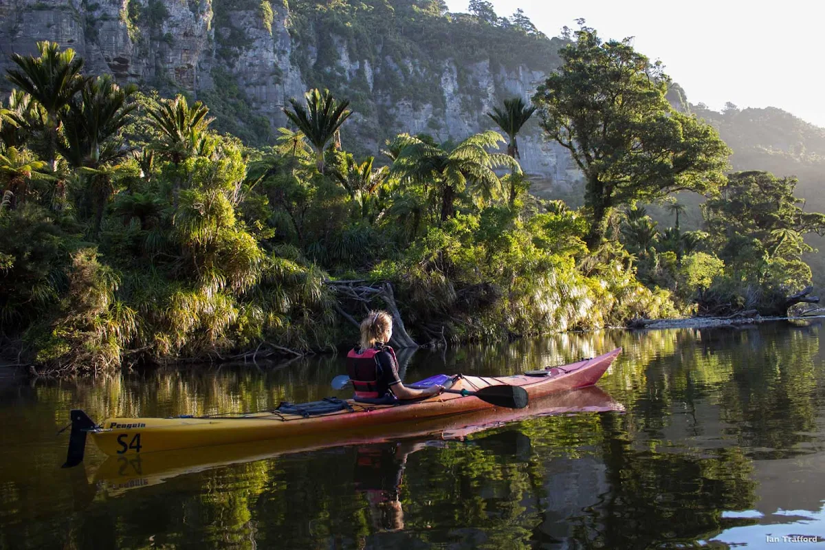 Kayaking_on_the_Pororari_Punakaiki - Next to Punakaiki village is the Pororari River, which opens out to a serene lagoon flanked by forest and cliffs on the west side of New Zealand's South Island. It’s the perfect location for a kayaking expedition. You don’t need to be especially fit or experienced to enjoy this adventure and all the gear is provided by the local kayak rental company.