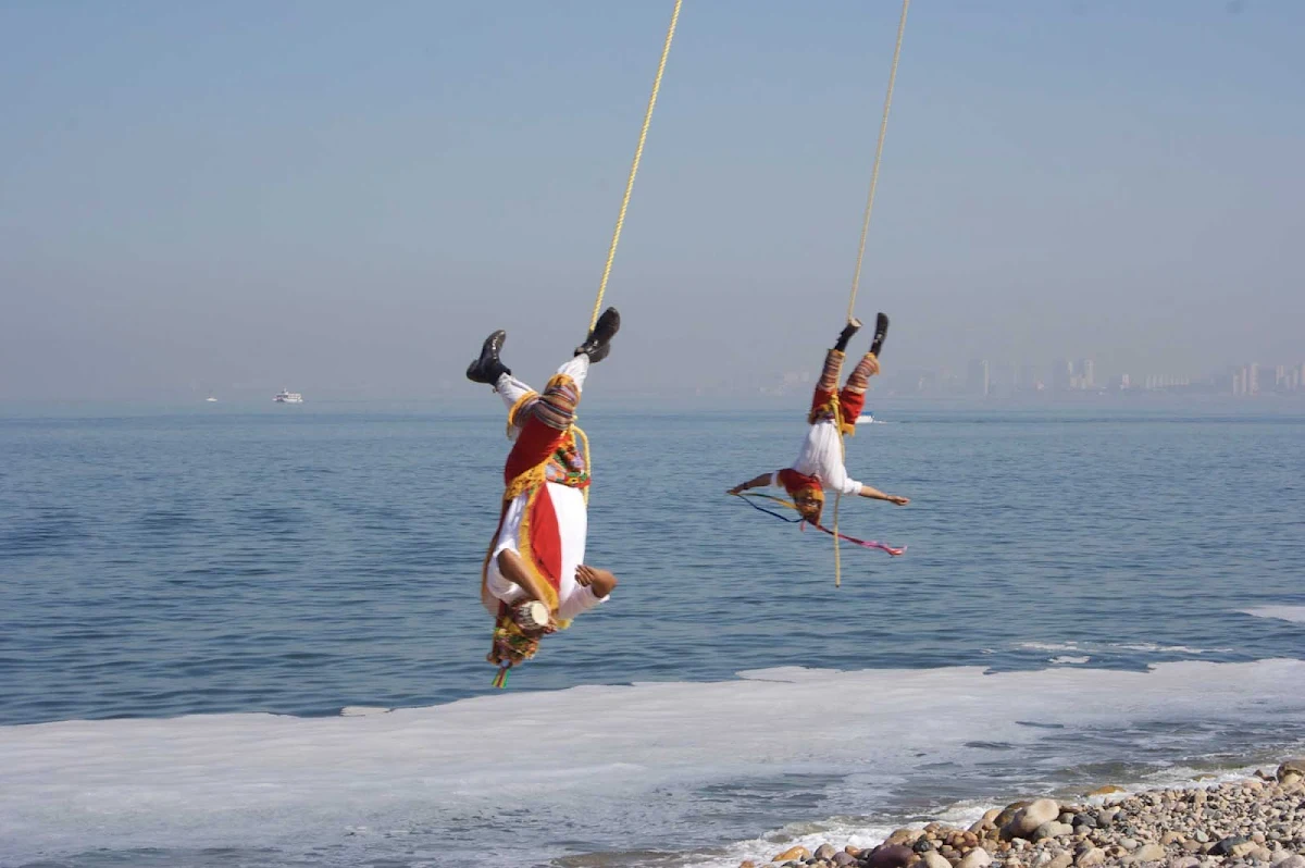 bird-men-Puerto-Vallarta-Mexico - The Voladores de Papantla (flyers of Papantla, also sometimes known as hombres pajaro, or "bird men") on the Melacon in Puerto Vallarta, Mexico.