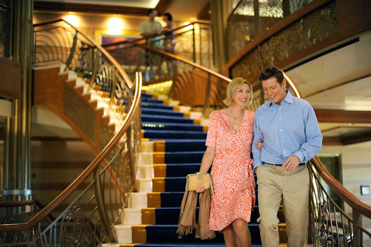 A couple on the large stairway on Disney Dream.