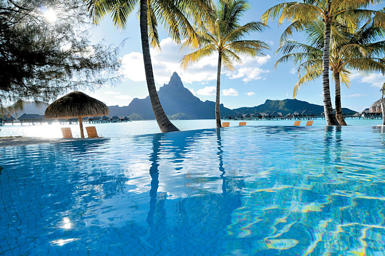 Reflect on this: The infinity pool at the InterContinental Bora Bora Resort, with Mount Otemanu in the background, is part of your Paul Gauguin cruise.