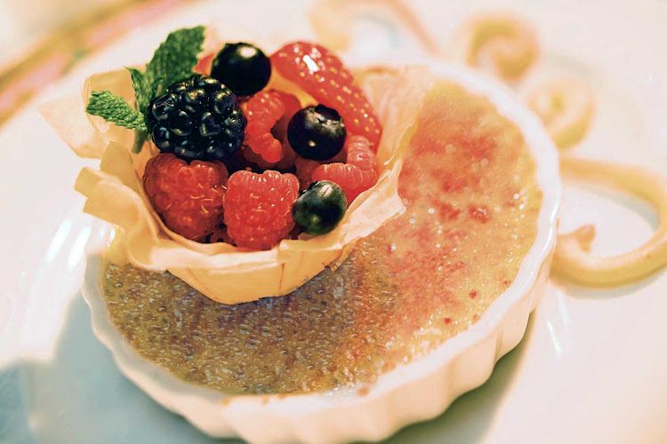 Leave room for dessert, like crème brûlée with a fruit topping, during your sailing aboard Norwegian Cruise Line. 