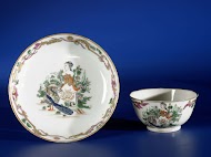 Bell-shaped cup and saucer with an elaboratly decorated monogram 'IDF'