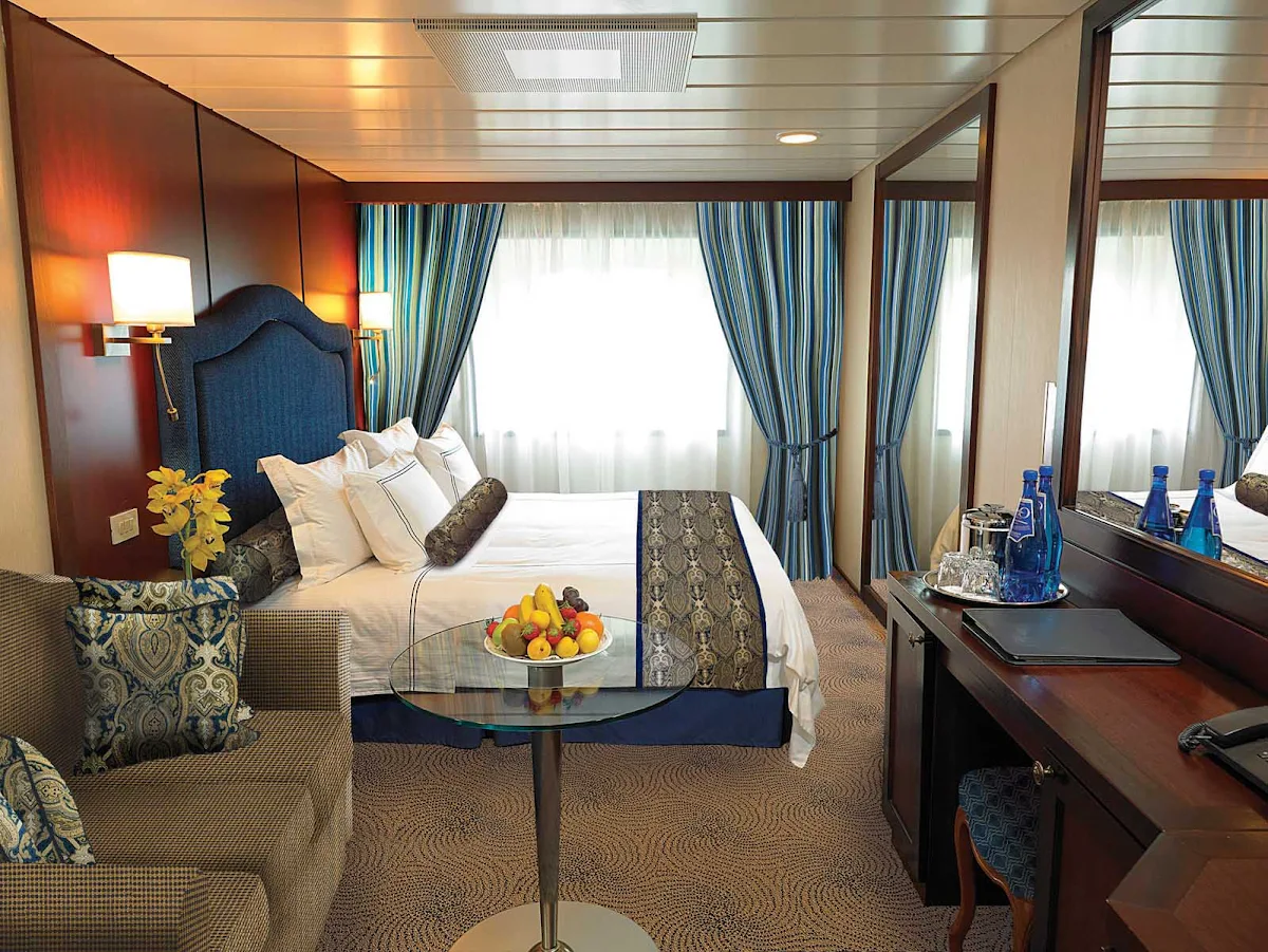 Oceania-C-Deluxe-Ocean-View-Stateroom - The C Level Deluxe Ocean View staterooms on Oceania Regatta contain custom-designed furnishings, queen or two twin bed accommodations, spacious seating area, vanity desk and breakfast table. At 165 square feet, they're located on decks 4,6 and 7.   