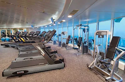 Work up a sweat with a view of the sea at Enchantment of the Seas' ShipShape Fitness Center.