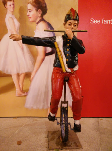 Boy with Flute Balancing on Unicycle
