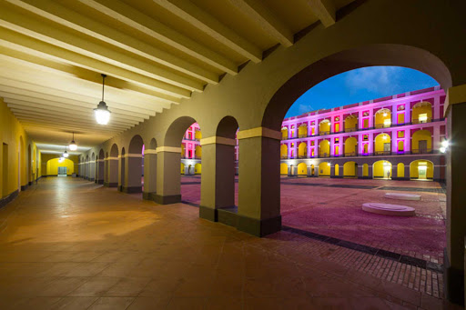 The Ballajá Barracks light up in the twilight in Old San Juan, Puerto Rico.